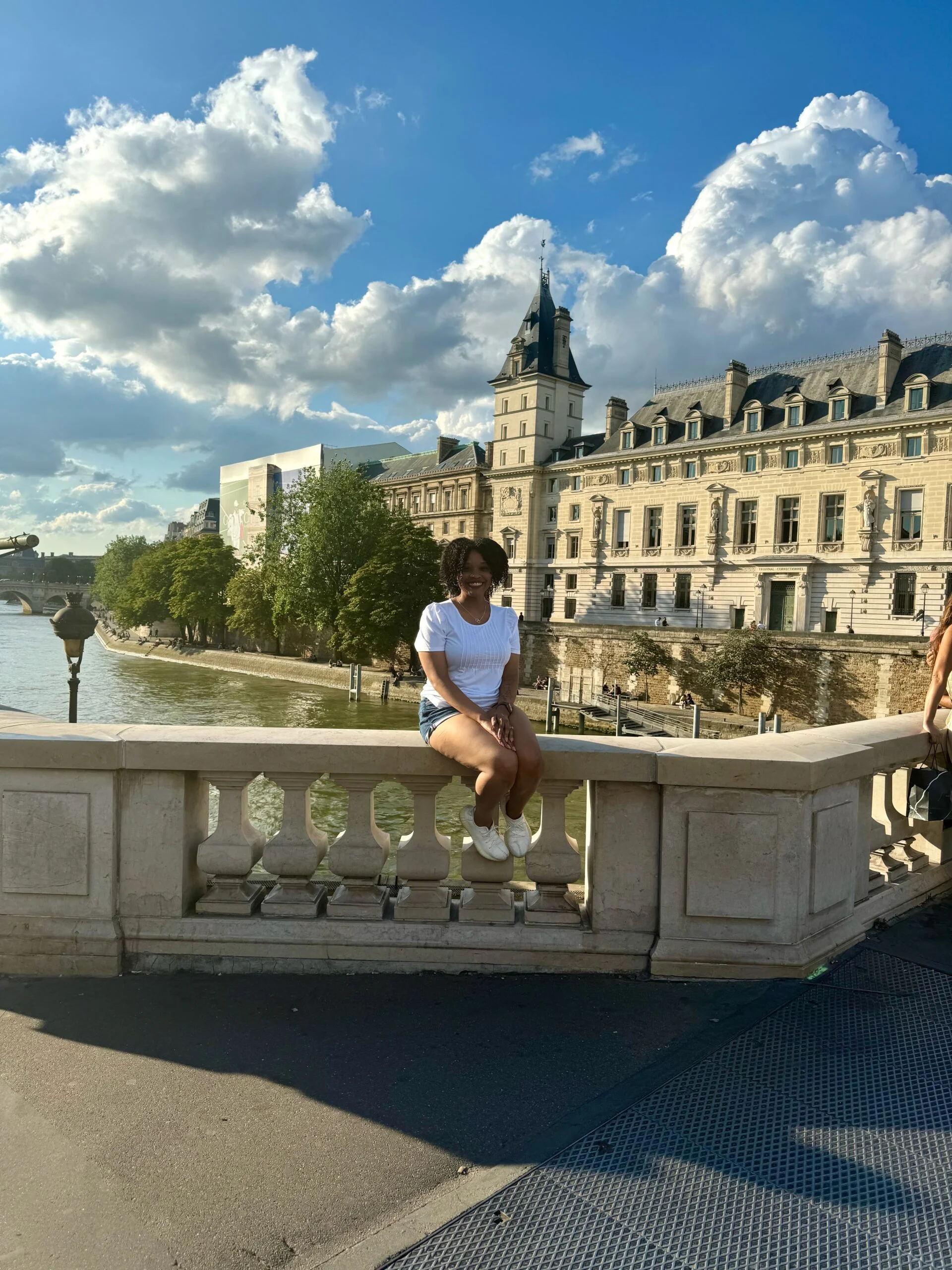 A girl sitting by the Seine river in Paris
